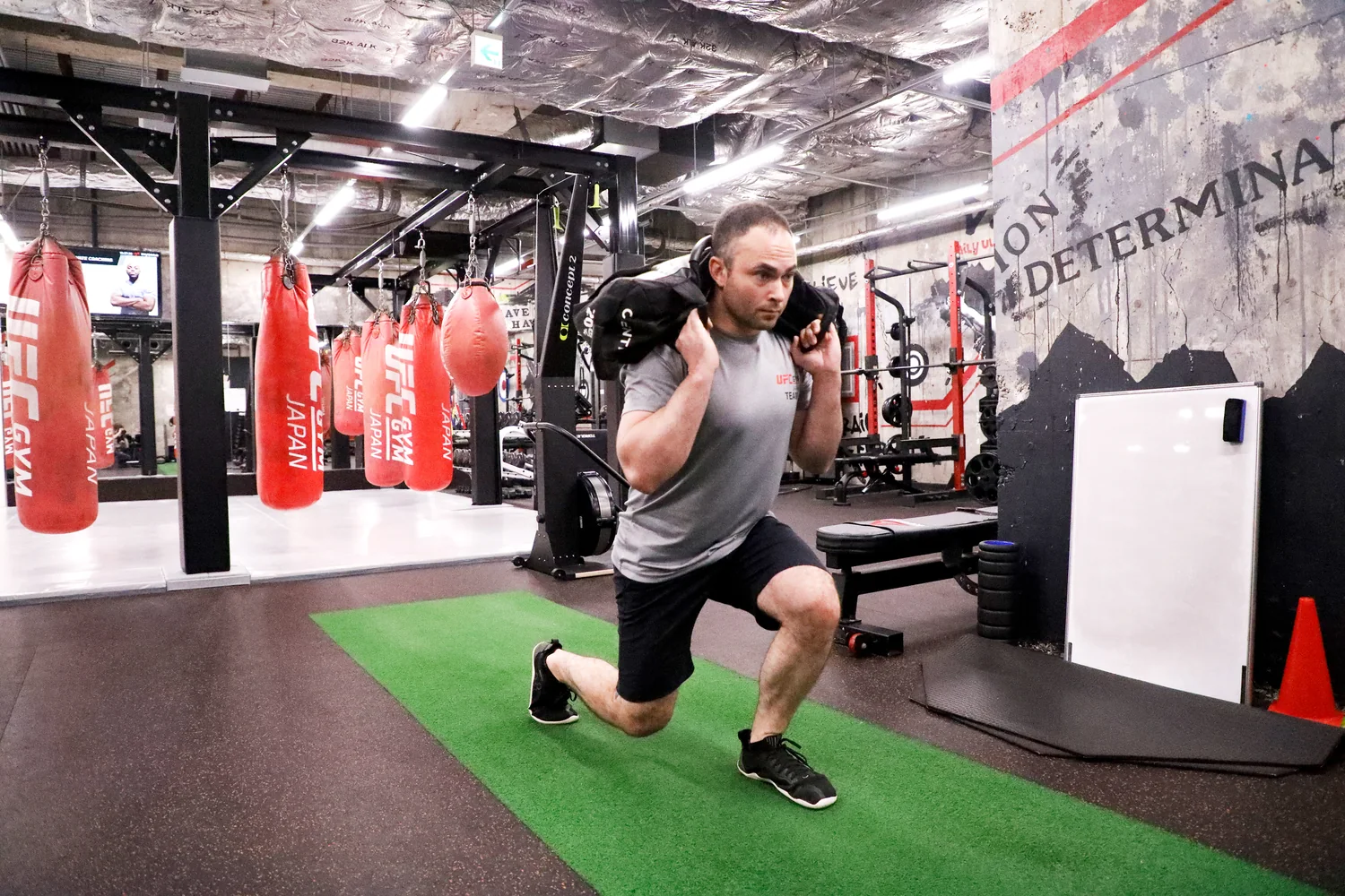 Sandbag lunges training at UFC Gym Ogikubo